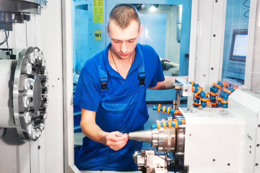 Worker operating CNC machine center