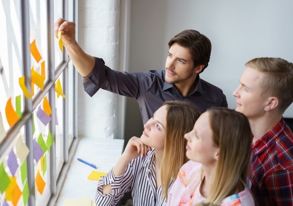 team entwickelt ideen und klebt zettel an ein fenster